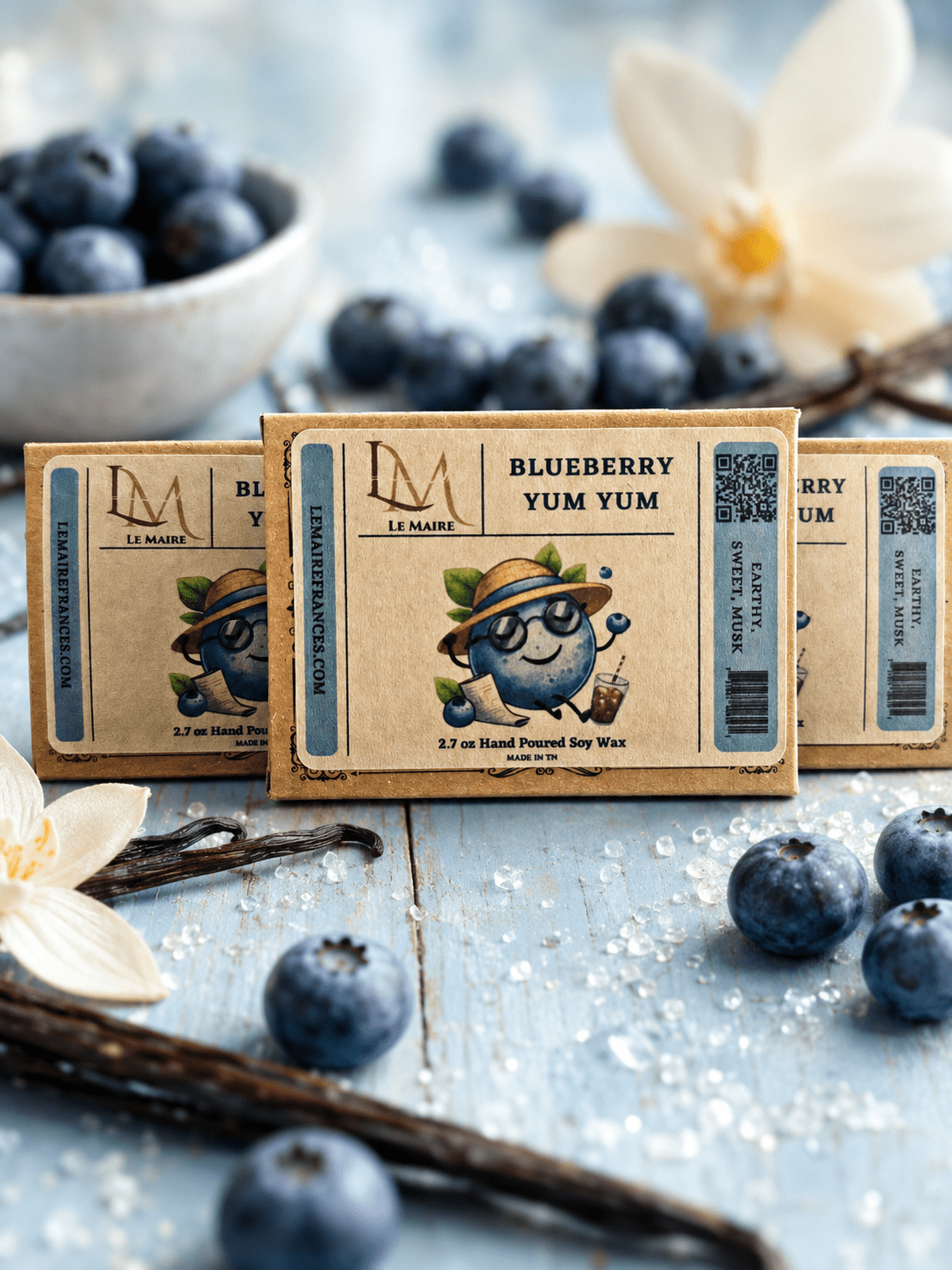 Three Blueberry Yum Yum wax melt boxes with earthy blueberry aroma styling