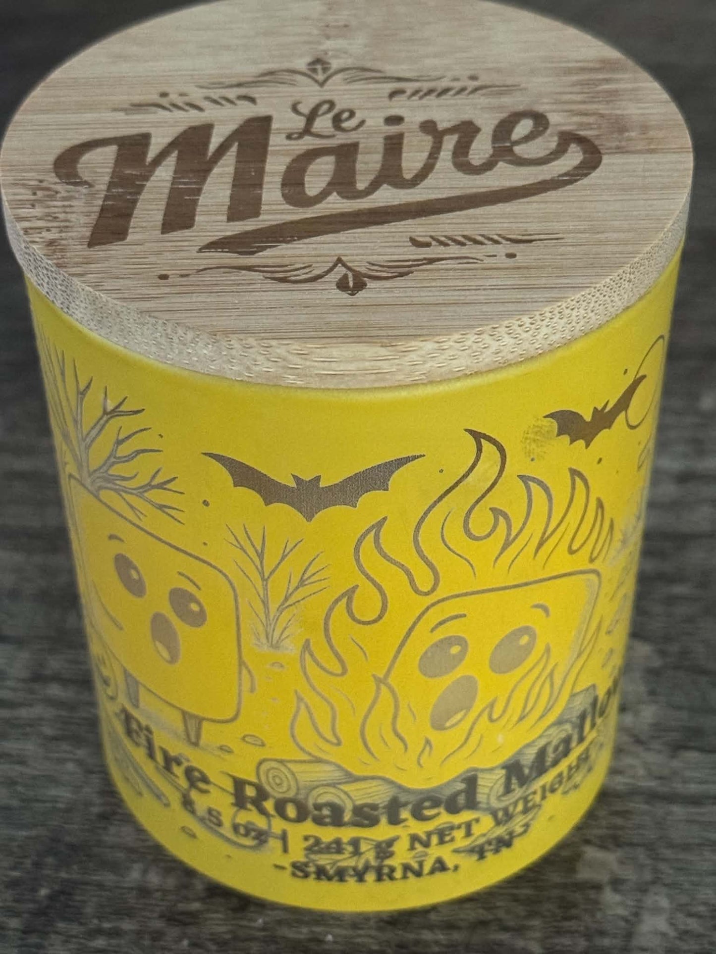 Fire Roasted Mallow soy candle angled view with yellow campfire jar and Le Maire wood lid