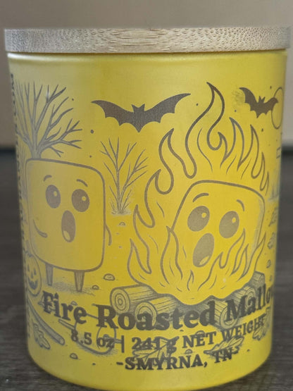 Fire Roasted Mallow soy candle front view with yellow campfire character jar