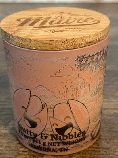 Nutty Nibbles pistachio vanilla soy candle angled view with Le Maire wood lid