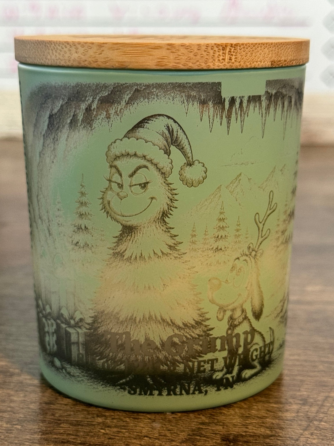 The Grump handmade fir soy candle front view in sage green jar